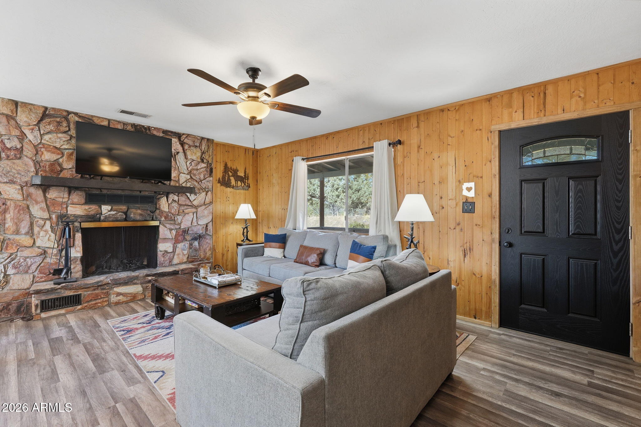8247 Ralls Drive Pine, AZ 85544 - Photo 8 of 50 a living room with furniture a flat screen tv and a fireplace