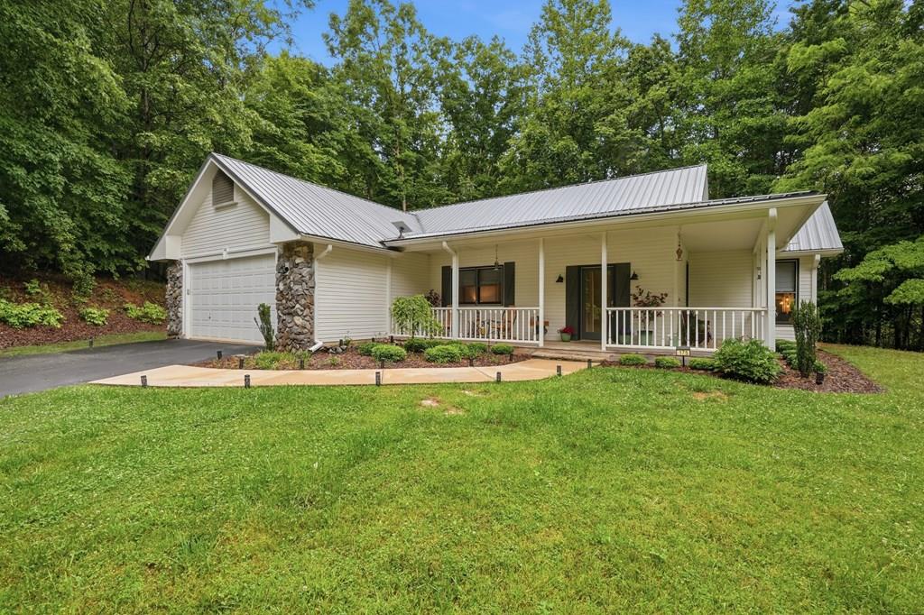 175 Crane Creek Road Young Harris, GA 30582 - Photo 1 of 40 a front view of house with yard and outdoor seating