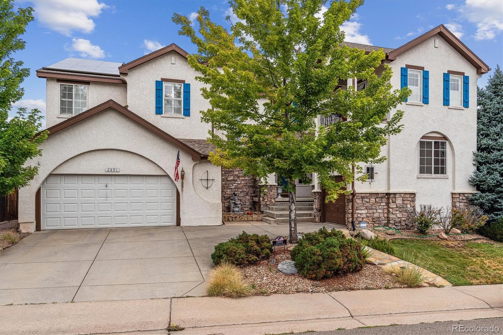 2891 Canyon Crest Drive Highlands Ranch, CO 80126 - Photo 1 of 41 a front view of a house with a yard and garage
