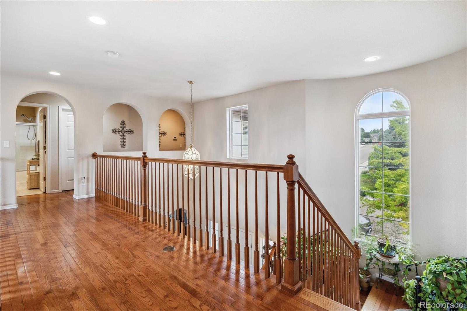 2891 Canyon Crest Drive Highlands Ranch, CO 80126 - Photo 25 of 41 a view of a room with wooden floor and windows