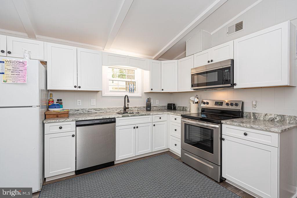 757 Ocean Parkway Ocean Pines, MD 21811 - Photo 16 of 29 a kitchen with cabinets stainless steel appliances and a window