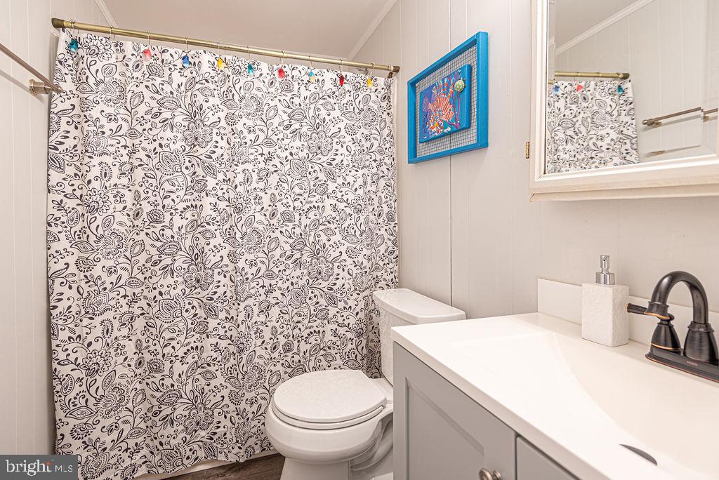 757 Ocean Parkway Ocean Pines, MD 21811 - Photo 17 of 29 a bathroom with a toilet and a shower curtain