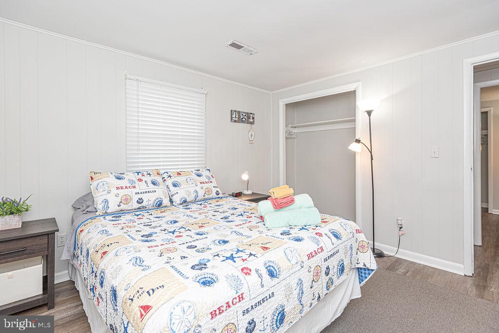 757 Ocean Parkway Ocean Pines, MD 21811 - Photo 19 of 29 a bedroom with a bed and a lamp