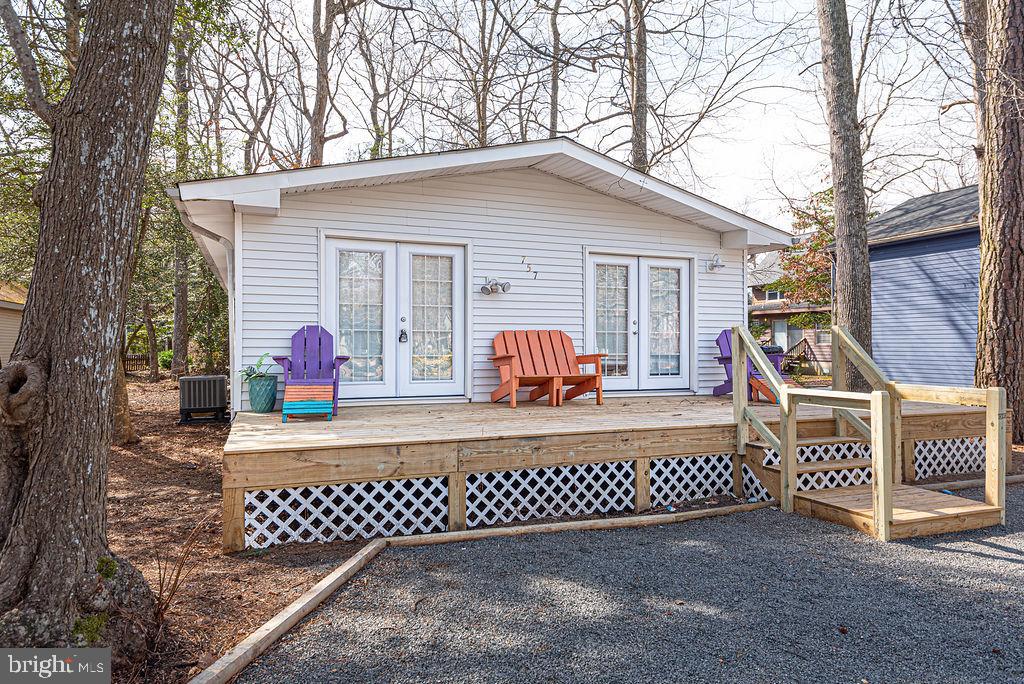 757 Ocean Parkway Ocean Pines, MD 21811 - Photo 23 of 29 a view of a house with a bench in a yard