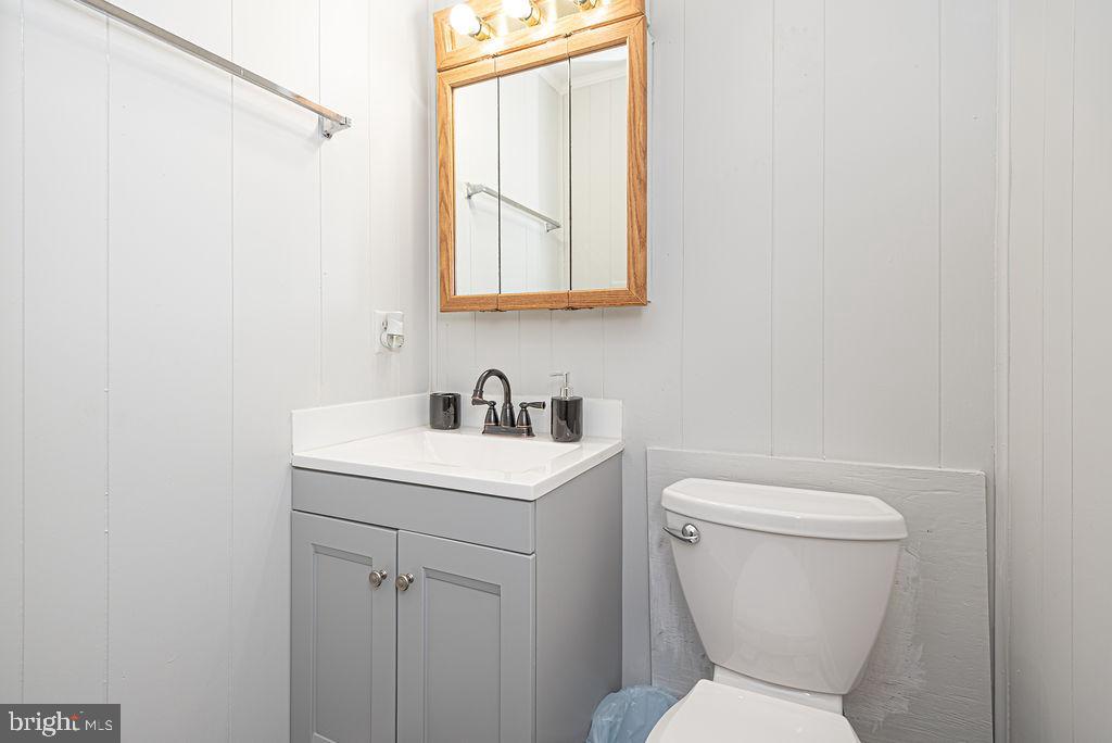 757 Ocean Parkway Ocean Pines, MD 21811 - Photo 5 of 29 a bathroom with a toilet sink and mirror
