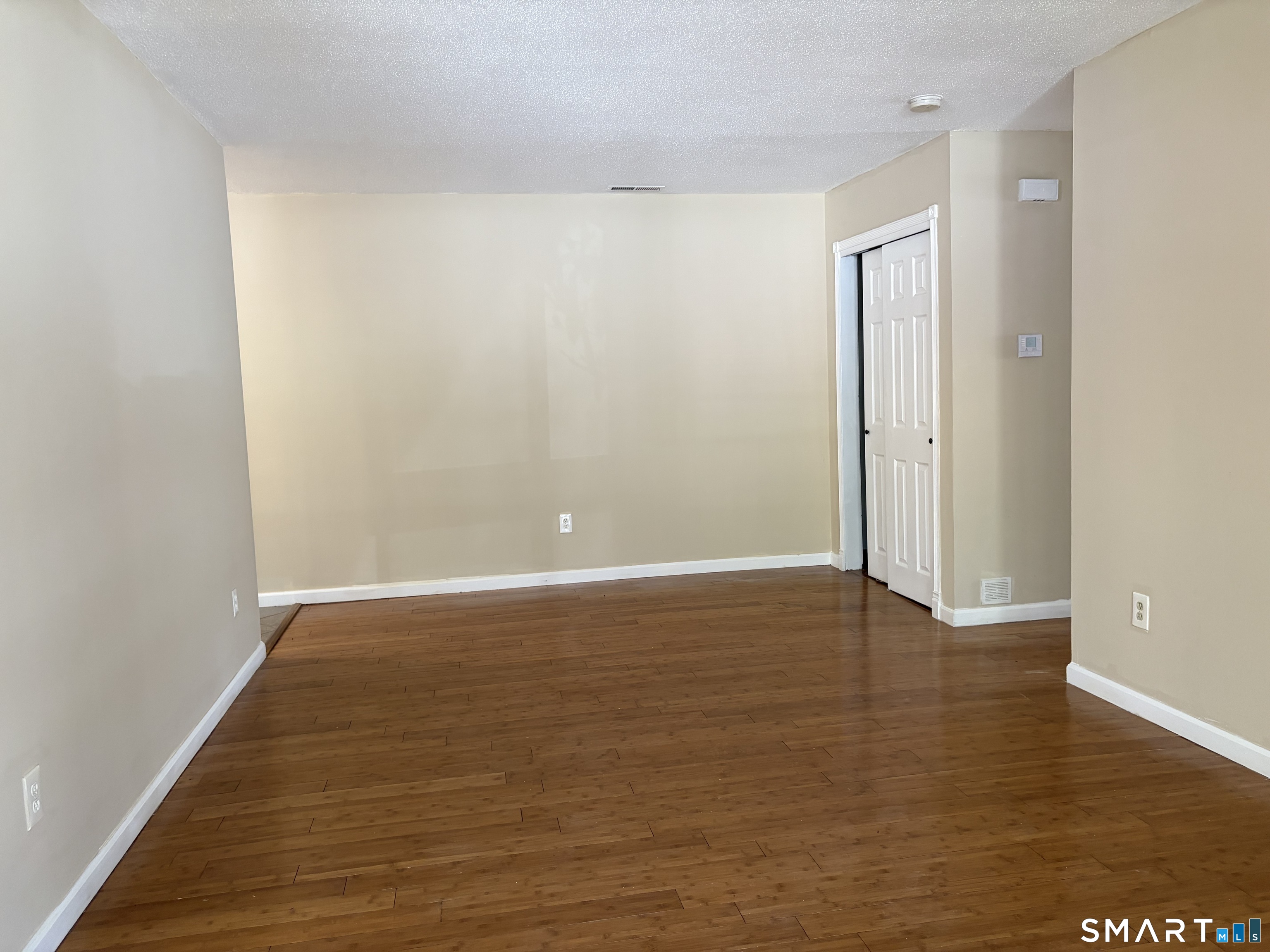 166 Old Brookfield Road, Unit 20B1 Danbury, CT 06811 - Photo 11 of 30 a view of an empty room with wooden floor