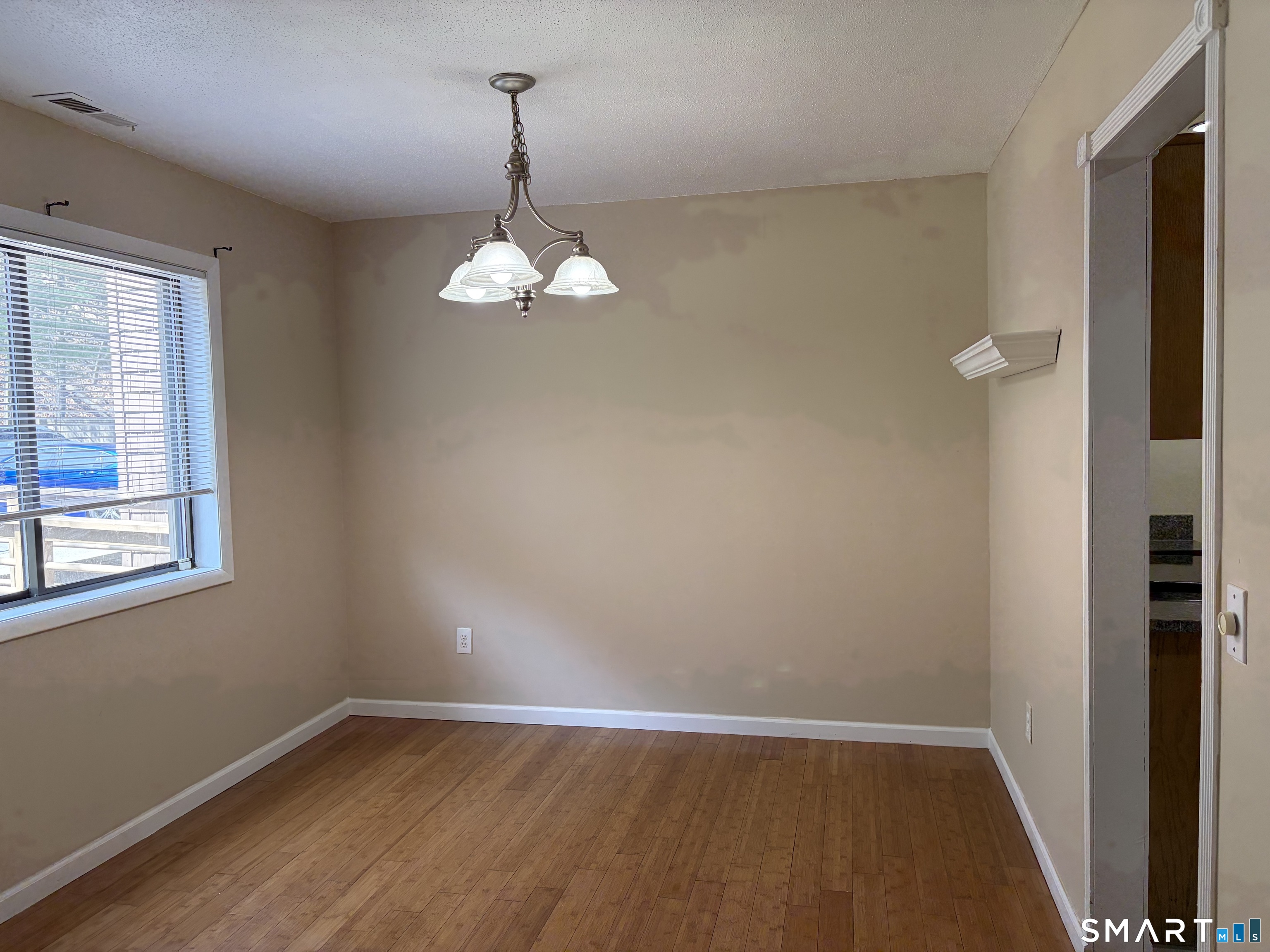 166 Old Brookfield Road, Unit 20B1 Danbury, CT 06811 - Photo 13 of 30 a view of an empty room with wooden floor and a window