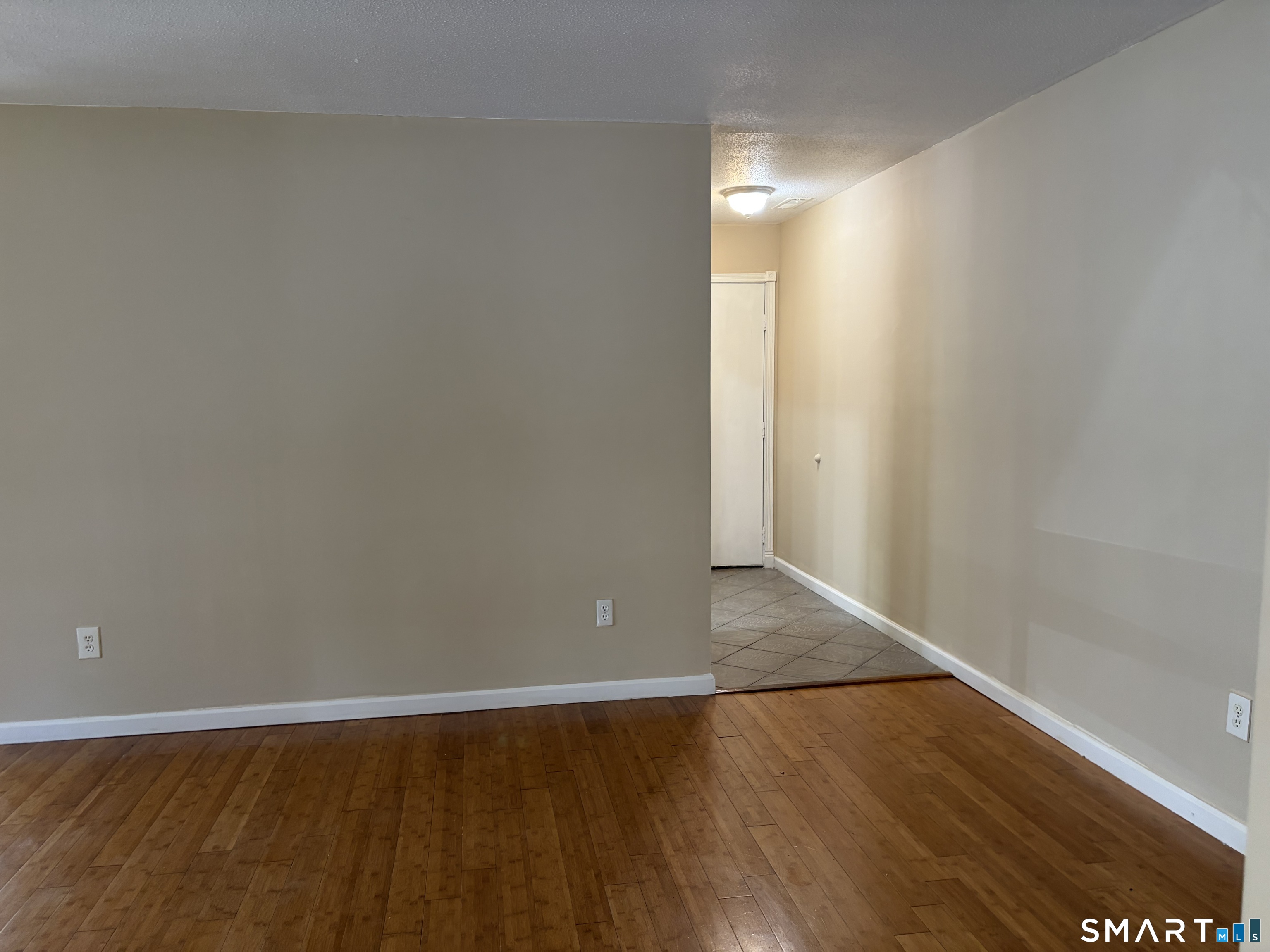 166 Old Brookfield Road, Unit 20B1 Danbury, CT 06811 - Photo 15 of 30 a view of an empty room with wooden floor