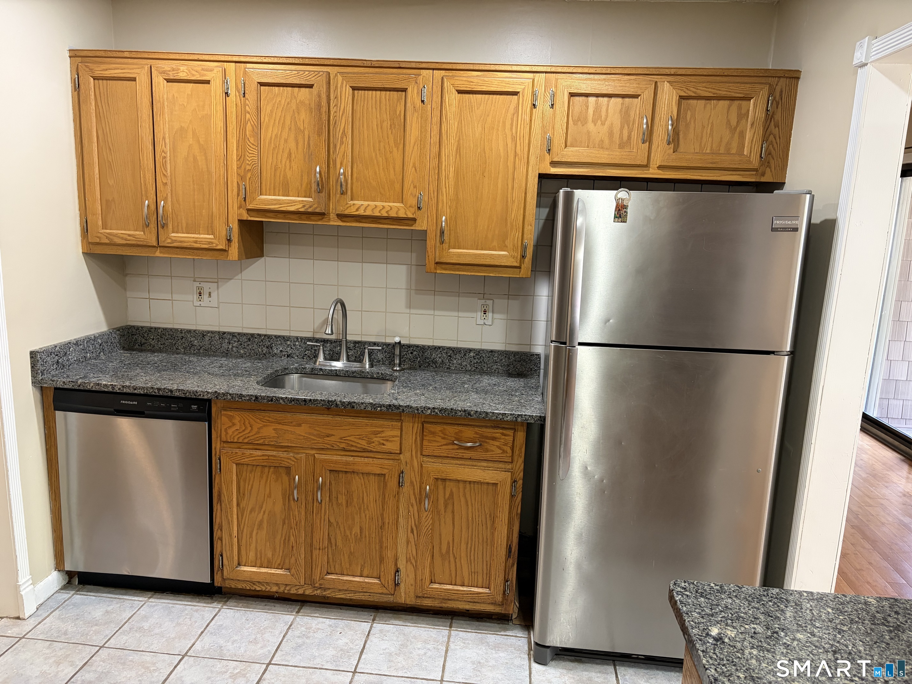 166 Old Brookfield Road, Unit 20B1 Danbury, CT 06811 - Photo 16 of 30 a kitchen with stainless steel appliances granite countertop a refrigerator and a sink