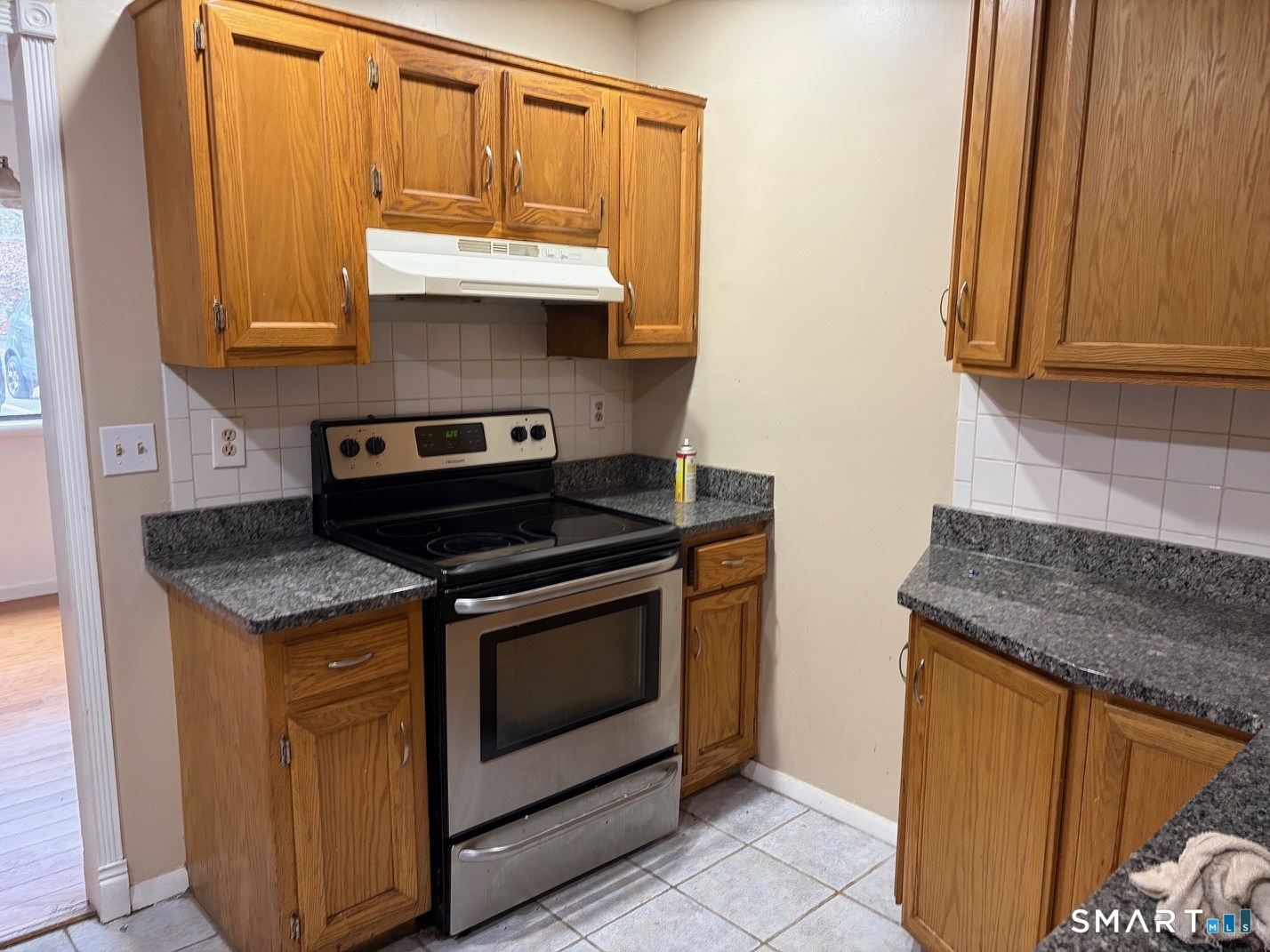 166 Old Brookfield Road, Unit 20B1 Danbury, CT 06811 - Photo 17 of 30 a kitchen with stainless steel appliances granite countertop a stove a sink and a microwave