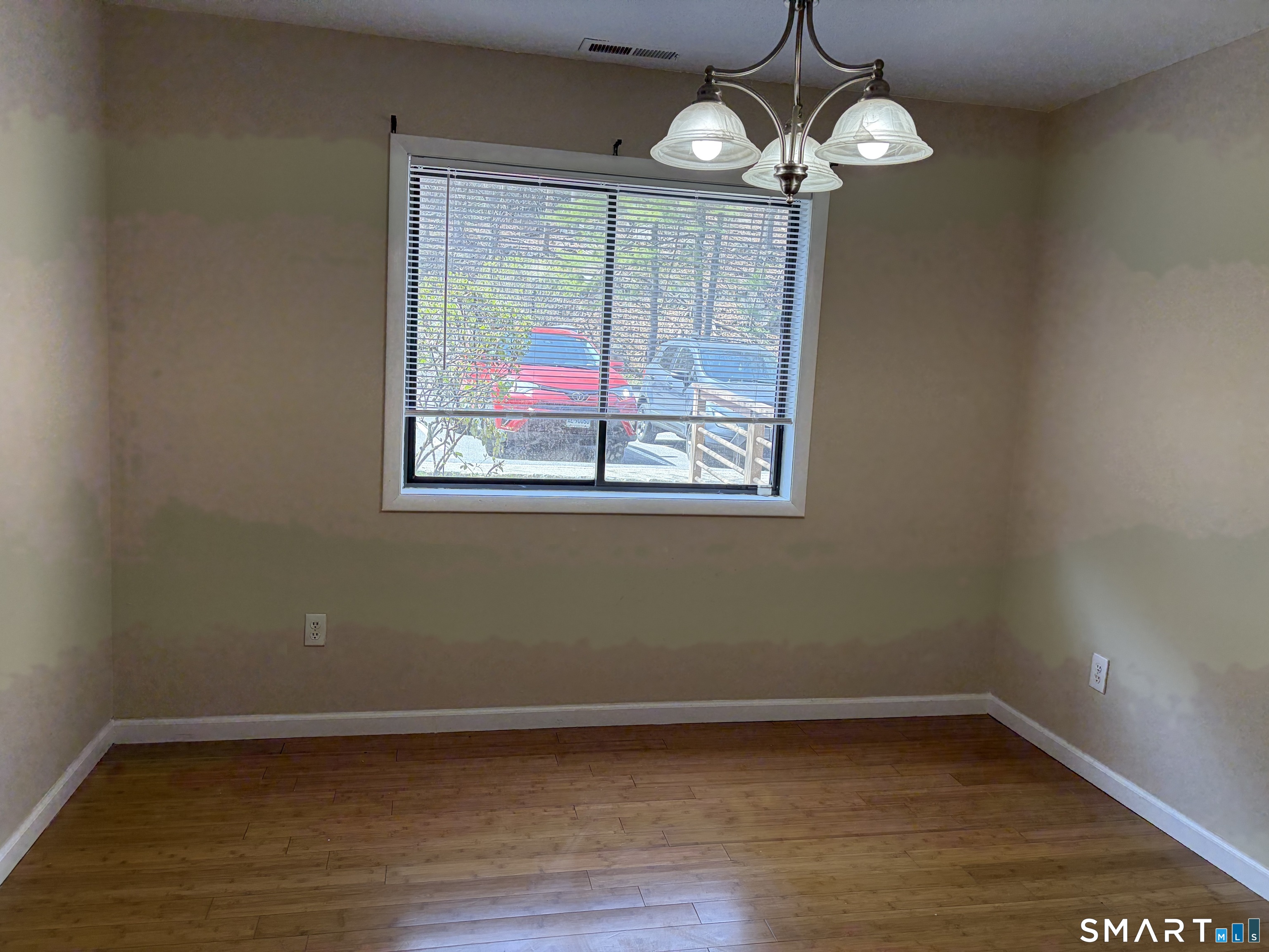 166 Old Brookfield Road, Unit 20B1 Danbury, CT 06811 - Photo 24 of 30 a view of a room with wooden floor and chandelier