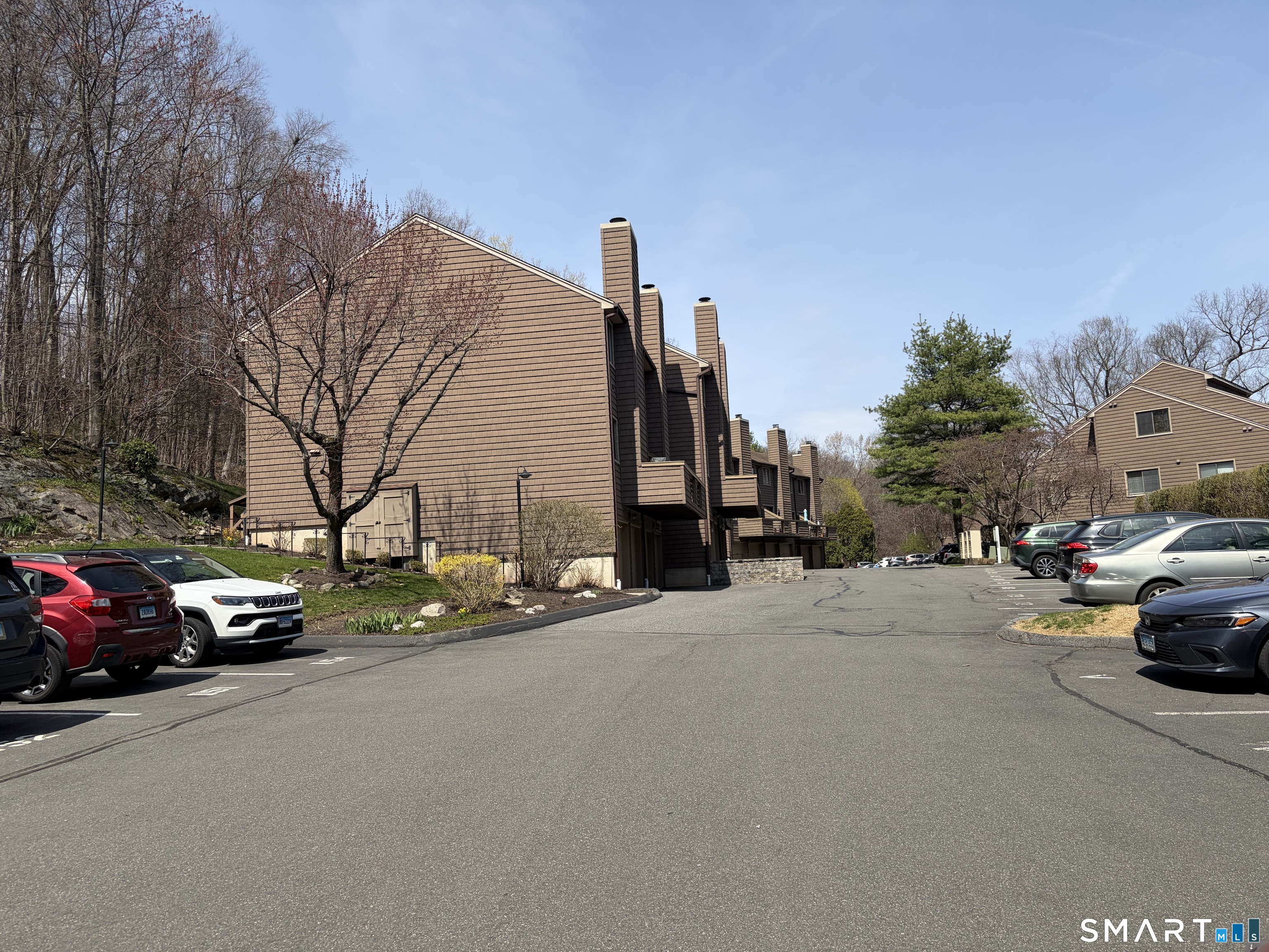 166 Old Brookfield Road, Unit 20B1 Danbury, CT 06811 - Photo 29 of 30 a car parked in front of a house