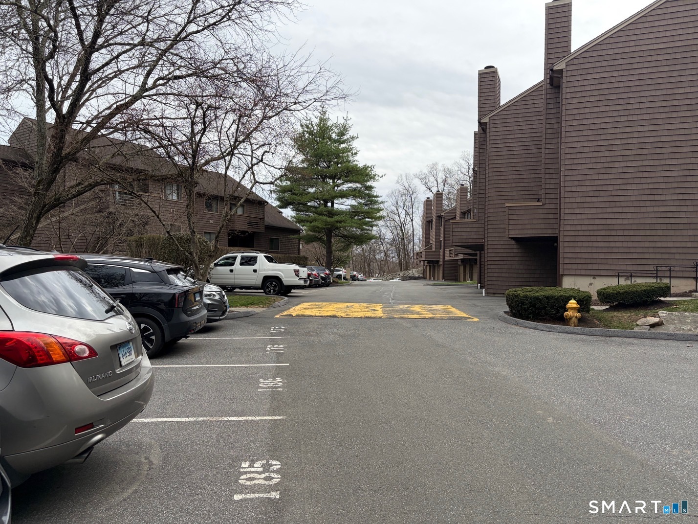 166 Old Brookfield Road, Unit 20B1 Danbury, CT 06811 - Photo 7 of 30 a view of street with parked cars