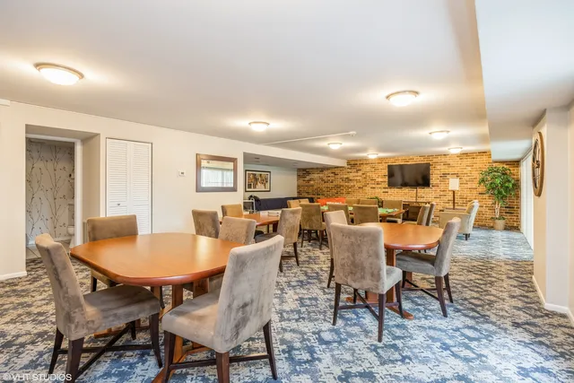 a dining room with furniture a rug and a painting