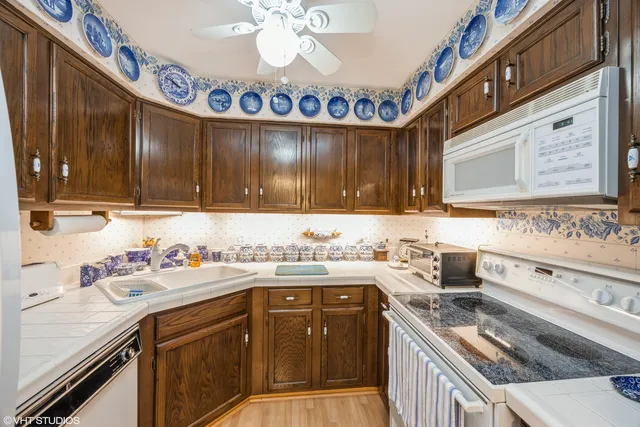 a kitchen with a sink stove top oven and cabinets