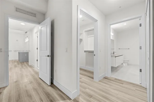 a lobby with furniture and chandelier