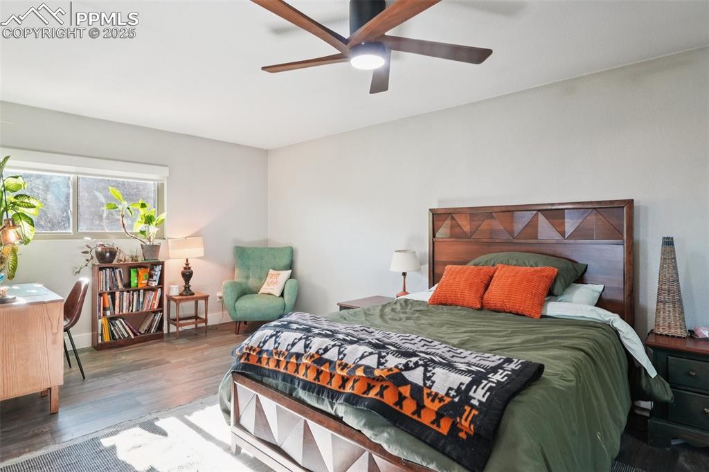 975 Crystal Park Road Manitou Springs, CO 80829 - Photo 17 of 38 a bedroom with a bed a table and chair
