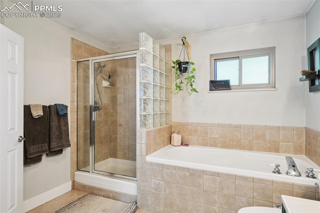 975 Crystal Park Road Manitou Springs, CO 80829 - Photo 19 of 38 a bathroom with a bathtub and a shower