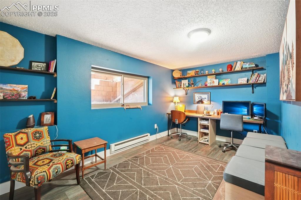 975 Crystal Park Road Manitou Springs, CO 80829 - Photo 20 of 38 a work room with furniture a rug and a window