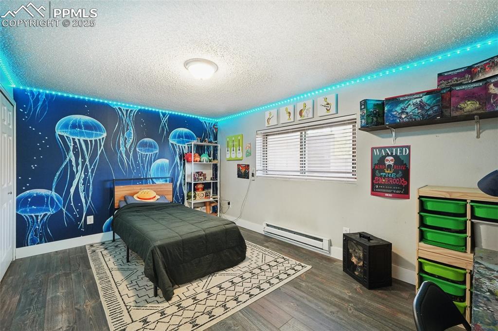 975 Crystal Park Road Manitou Springs, CO 80829 - Photo 22 of 38 a bedroom with a bed and a couch