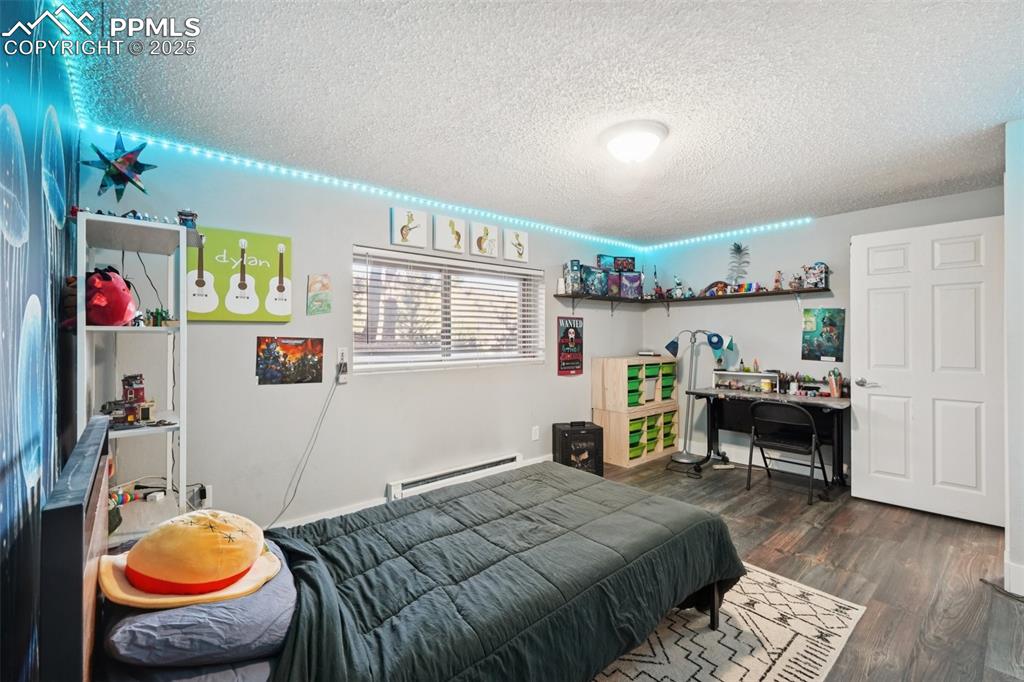 975 Crystal Park Road Manitou Springs, CO 80829 - Photo 23 of 38 a bedroom with a bed and a dresser