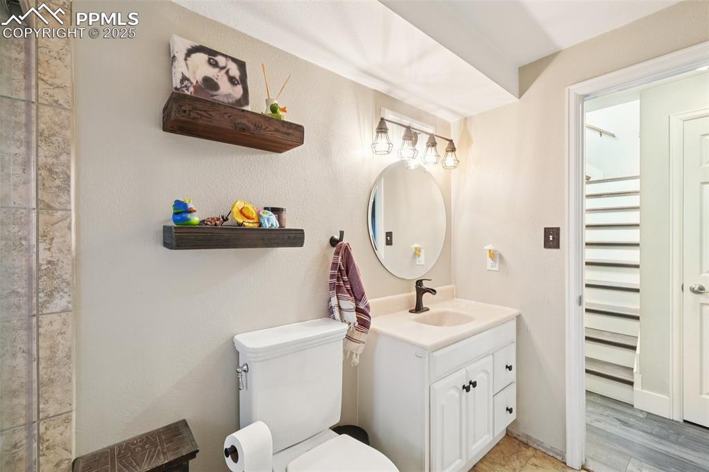 975 Crystal Park Road Manitou Springs, CO 80829 - Photo 25 of 38 a bathroom with a toilet sink and mirror