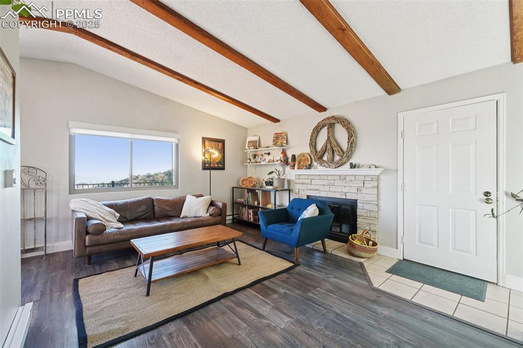975 Crystal Park Road Manitou Springs, CO 80829 - Photo 6 of 38 a living room with furniture and a fireplace