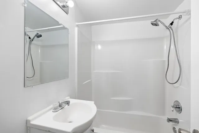 a view of a room with wooden floor and white walls