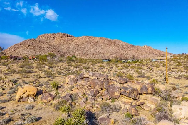 a view of a large mountain with mountains in the background