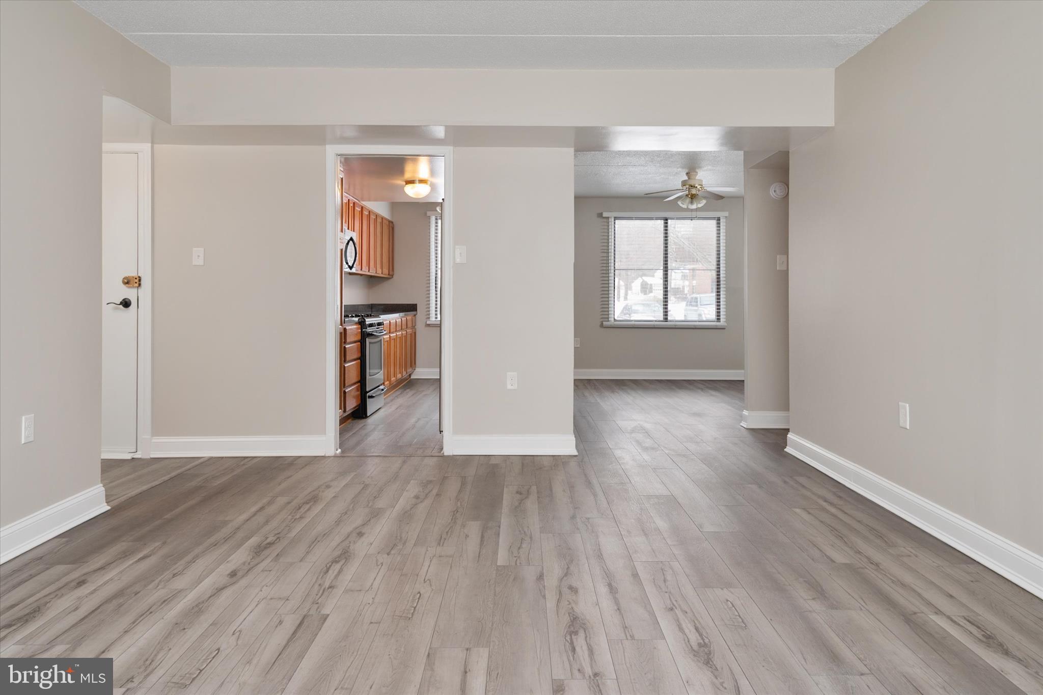 5245 West Running Brook Road, Unit 101 Columbia, MD 21044 - Photo 11 of 33 wooden floor in an empty room with a window