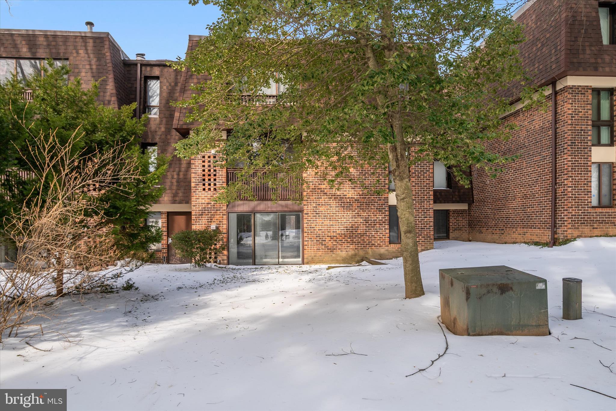 5245 West Running Brook Road, Unit 101 Columbia, MD 21044 - Photo 30 of 33 a brick building with a large tree