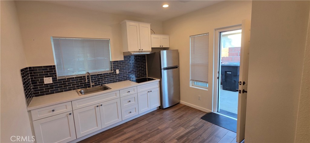 1496 Powell Riverside, CA 92501 - Photo 3 of 7 a kitchen with cabinets and wooden floor