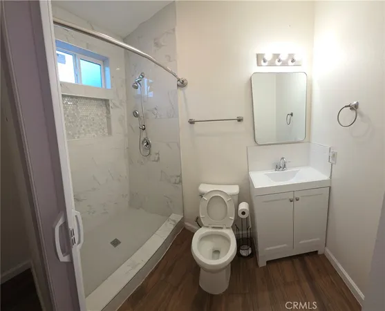 a bathroom with a toilet sink and shower