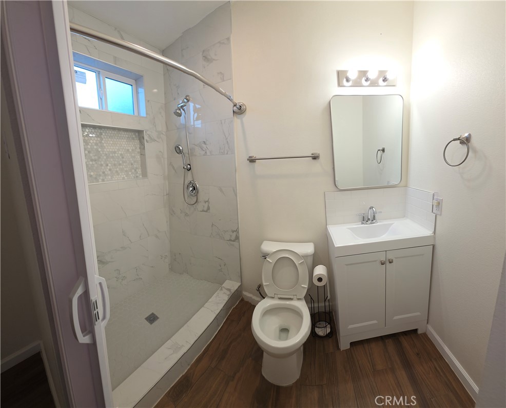 1496 Powell Riverside, CA 92501 - Photo 5 of 7 a bathroom with a toilet sink and shower