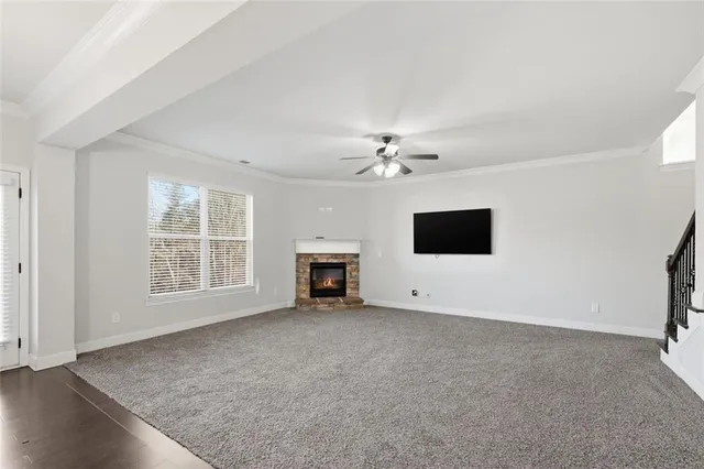 a view of an empty room with a fireplace and a window