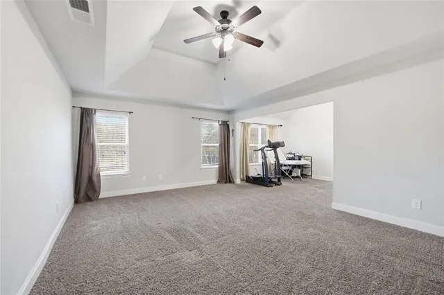 a view of a livingroom with a ceiling fan and a projector