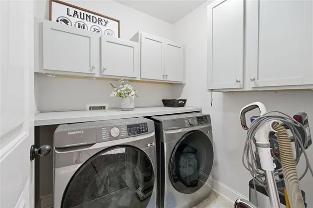 a living room with furniture or couch and a chandelier