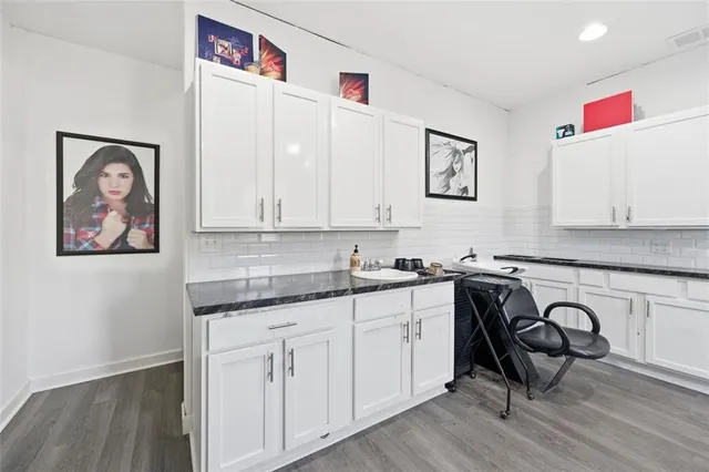 a kitchen with kitchen island stainless steel appliances a sink and a refrigerator