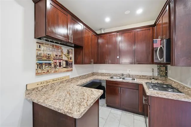 a view of a livingroom with wooden floor and furniture