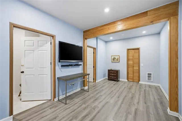 a view of a livingroom with wooden floor and a flat screen tv