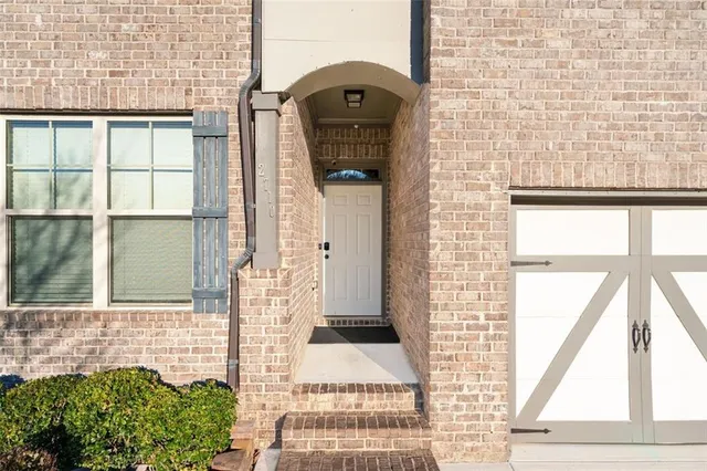 a view of a brick house with a large windows
