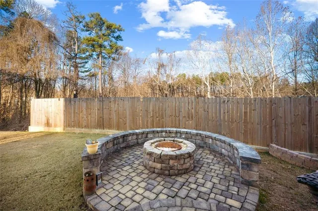 a backyard of a house with table and chairs