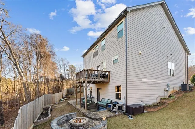 a view of a patio with a table and chairs under an umbrella