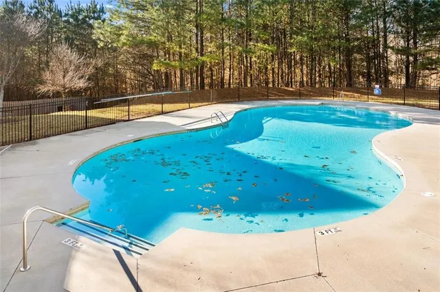 a view of a swimming pool with a yard