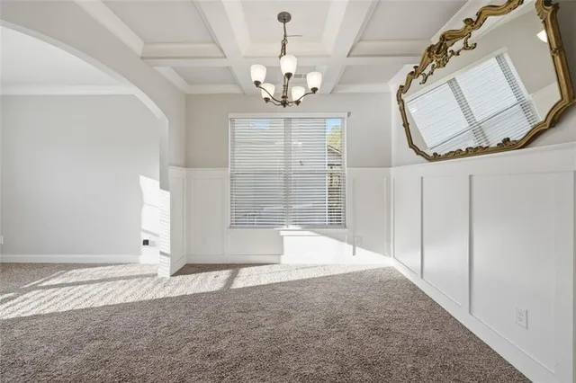 an empty room with wooden floor and mirror