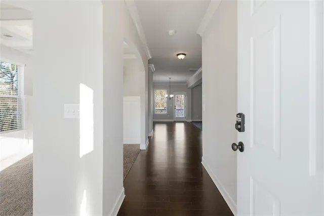 a view of a hallway with wooden floor