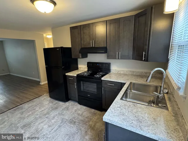 a kitchen with granite countertop stainless steel appliances and wooden cabinets