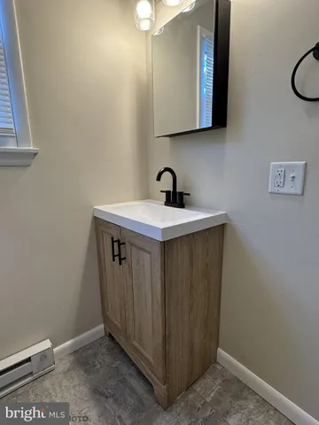 a bathroom with a sink and a mirror