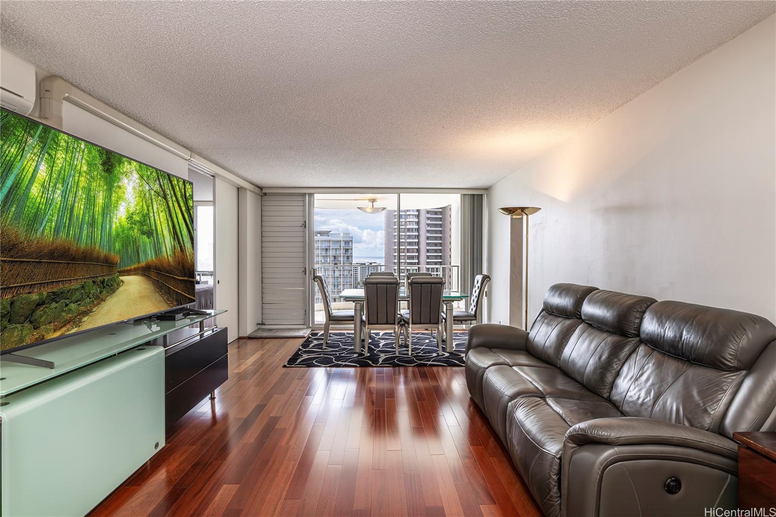 469 Ena Road, Unit 2205 Honolulu, HI 96815 - Photo 2 of 21 a living room with furniture and a large window