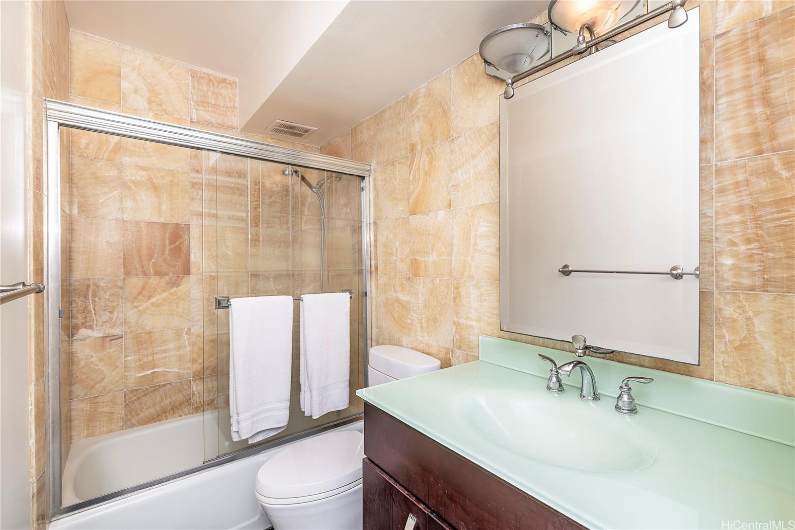 469 Ena Road, Unit 2205 Honolulu, HI 96815 - Photo 10 of 21 a bathroom with a sink toilet and shower